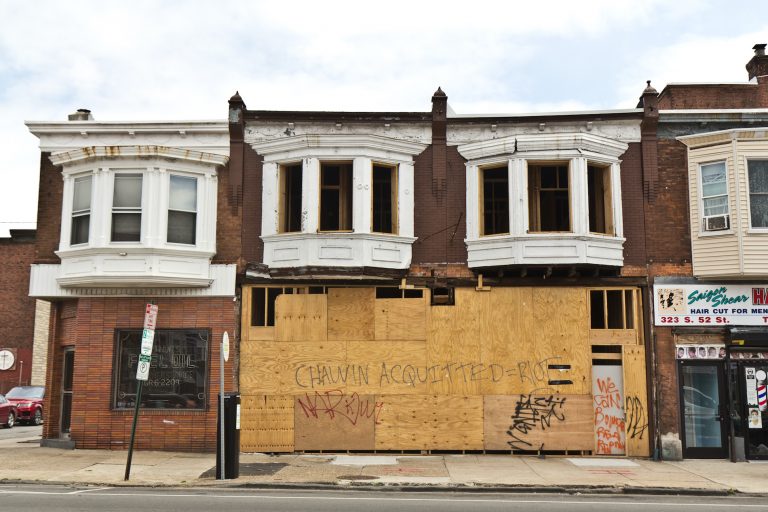 Graffiti on a boarded-up home under construction at 52nd and Delancey streets warn of unrest if the killer of George Floyd is not convicted