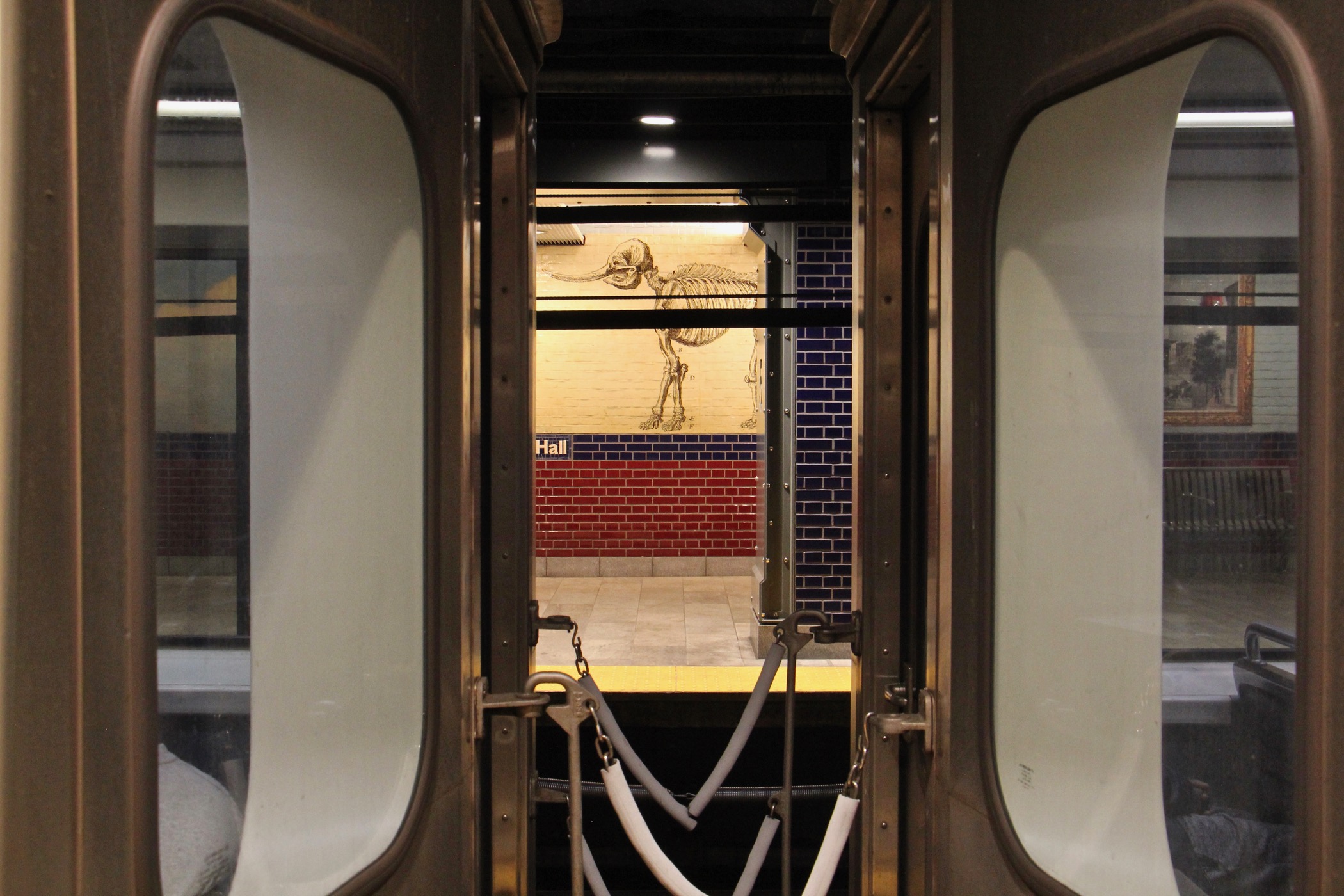 Rembrandt Peale's 1801 drawing of a mastadon skeleton is visible between cars at the Independence Hall SEPTA Station. (Emma Lee/WHYY)