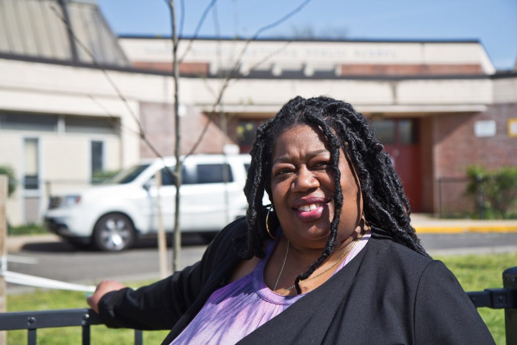 2021-04-20-k-paynter-tree-planting-mary-mcleod-bethune-elementary-5 Mary McLeod Bethune Elementary Principal Aliya Catanch-Bradley stands in front of trees planted in Fall 2020. (Kimberly Paynter/WHYY)