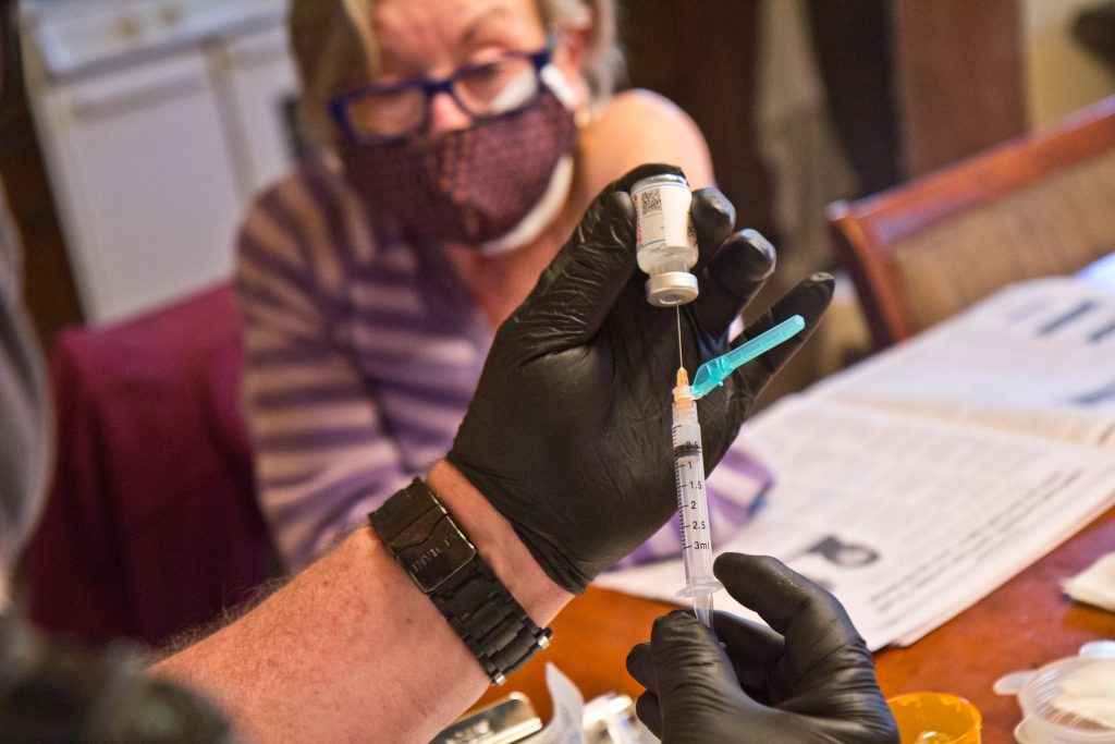 2021-04-6-k-paynter-delco-home-vaccination-3 Paramedic Jim McCanns prepares a first dose of the Moderna COVID-19 vaccine for Lucille Breslin at her home in Upper Darby on April 6, 2021. (Kimberly Paynter/WHYY)
