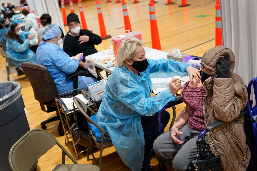 Virus Outbreak Walk-In Clinic New Jersey Miriam Palomino, right, receives the COVID-19 vaccine in Paterson