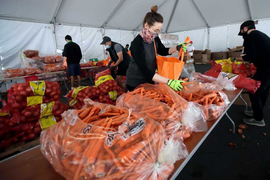 Food Assistance Increase FILE - In this April 18, 2020, file photo, San Francisco-Marin Food Bank volunteers pack food into bags to be delivered to people in San Francisco. About 25 million Americans will be eligible for more food assistance money under a new policy adopted by President Joe Biden's administration under a change announced Thursday, April 1, 2021. (AP Photo/Jeff Chiu, File)