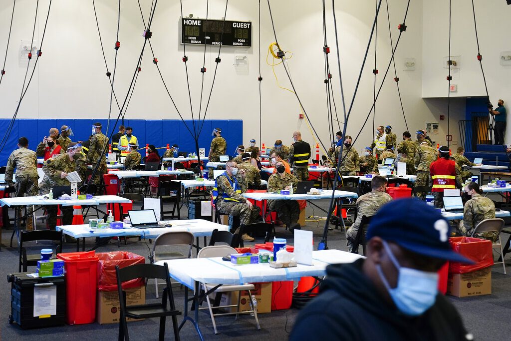 Virus Outbreak Pennsylvania Members of the military inoculate people with the Johnson & Johnson COVID-19 vaccine at the Esperanza Community Vaccination Center in Philadelphia, Friday, April 9, 2021. (AP Photo/Matt Rourke)