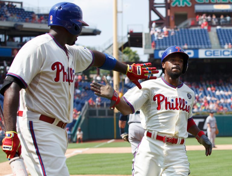 In this Aug. 20, 2014, file photo, Philadelphia Phillies' Jimmy Rollins, right, celebrates his run with Ryan Howard on a single by Chase Utley during the fifth inning of the team's baseball game against the Seattle Mariners in Philadelphia. When Rollins made his first All-Star team as a rookie with the Phillies 20 years ago, the percentage of Black players in the majors was 13. It’s down to 7.6% this year. Rollins pointed to Ken Griffey Jr. and Barry Bonds as popular players who were marketed well when he was growing up. “But when you start going outside of that select few, the sport itself isn’t marketing anyone else in a major way where kids from the inner cities are attracted to it,