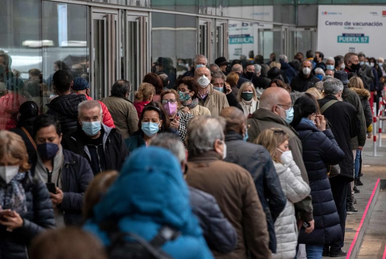 In this April 9, 2021, file photo, people queue to be vaccinated with the AstraZeneca vaccine against COVID-19 during a vaccination campaign at WiZink indoor arena in Madrid, Spain. (AP Photo/Manu Fernandez)