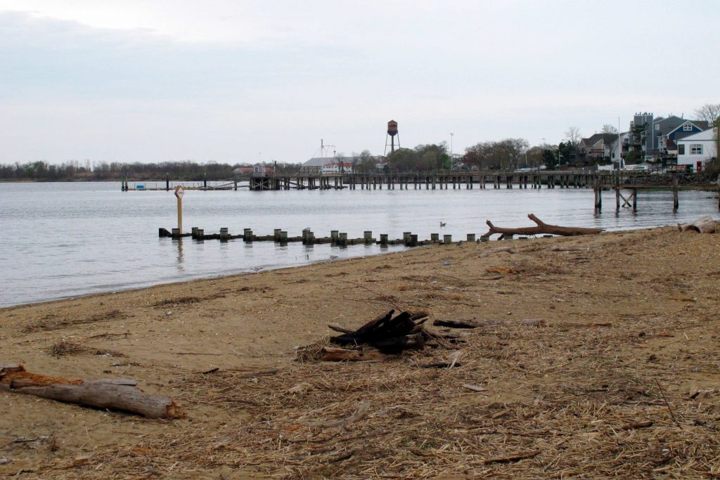 This Tuesday, April 19, 2021 photo shows the waterfront of Raritan Bay in Keyport, N.J. A Massachusetts company wants to build a high-voltage power line that would come ashore in Keyport and connect electricity from a future wind farm off the New Jersey coast to the onshore electrical grid. (AP Photo/Wayne Parry)