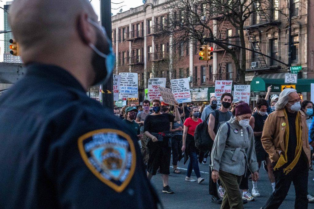 George Floyd Officer Trial New York Police officers keep a watchful eye as peaceful protesters march down Flatbush Avenue on Tuesday, April 20, 2021, in the Brooklyn borough of New York. Former Minneapolis police Officer Derek Chauvin has been convicted of murder and manslaughter in the death of George Floyd, the explosive case that triggered worldwide protests, violence and a furious reexamination of racism and policing in the U.S. Floyd died last May after Chauvin, a white officer, pinned his knee on or close to the 46-year-old Black man's neck for about 9 1/2 minutes. (AP Photo/Brittainy Newman)