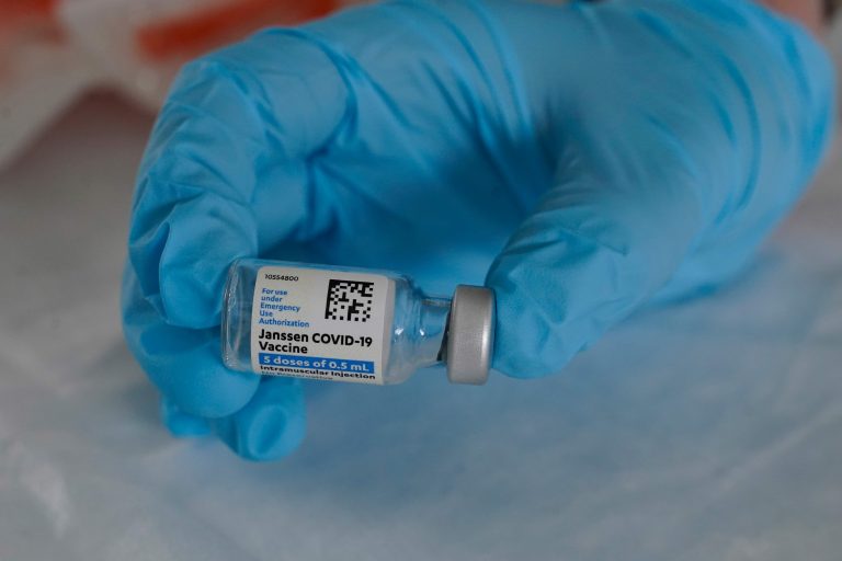 In this March 3, 2021, file photo, U.S. Army medic Kristen Rogers, of Waxhaw, N.C., holds a vial of the Johnson & Johnson COVID-19 vaccine in North Miami, Fla. (AP Photo/Marta Lavandier)
