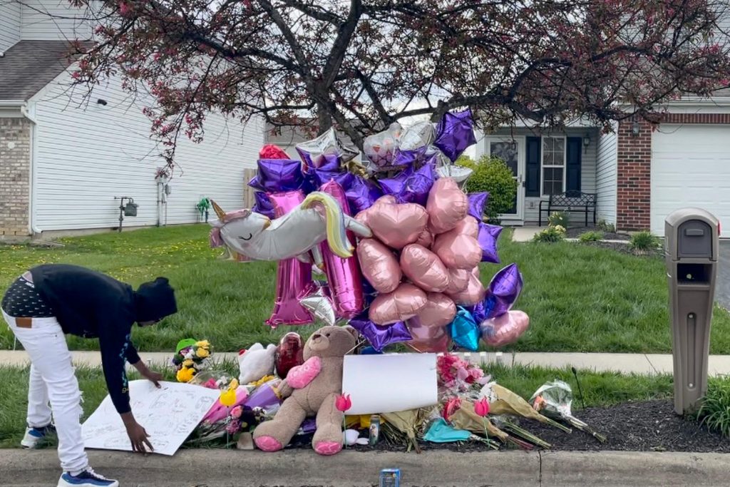 Columbus Police Shooting A man adjusts a sign near a memorial at the scene in the Columbus, Ohio neighborhood Friday, April 23, 2021 where 16-year-old Ma'Khia Bryant was fatally shot by police as she swung at two other people with a knife on Tuesday, April 20. (AP Photo/Farnoush Amiri)