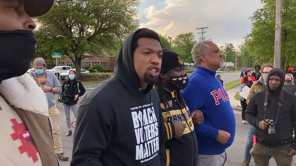 In this image taken from video, Quentin Jackson, regional director for the National Black Caucus of Local Elected Officials, addresses protesters blocking Business U.S. 17 in Elizabeth City, N.C., on Thursday, April 22, 2021. (AP Photo/Allen G. Breed)