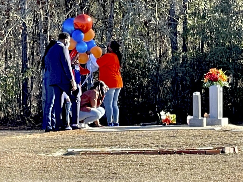 Citizens Arrest Georgia FILE - In this Feb. 23, 2021, file photo, Wanda Cooper-Jones kneels before the grave of her son, Ahmaud Arbery, at the New Springfield Baptist Church in Waynesboro, Ga., to mark the one year anniversary of Ahmaud Arbery's death in Brunswick, Ga. The Justice Department announced federal hate crime charges Wednesday, April 28, 2021, in the death of Arbery, who was killed while out for a run.(AP Photo/Lewis M. Levine, file)