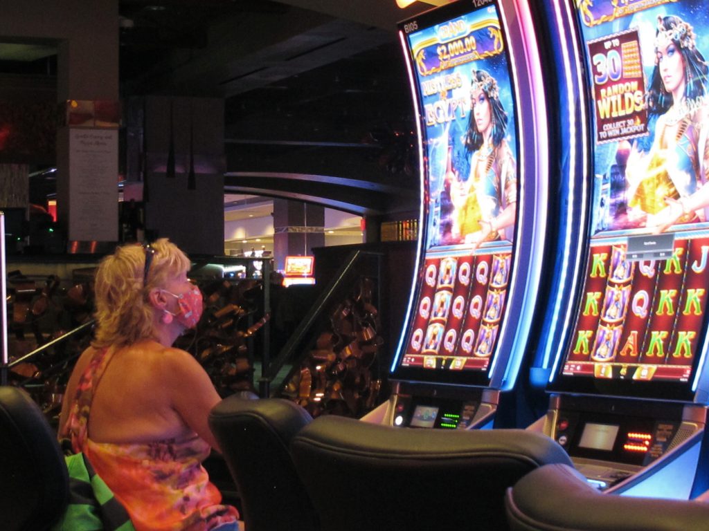 Earns-Atlantic City Casinos File photo: A woman plays a slot machine at the Golden Nugget casino in Atlantic City N.J. in this July 2, 2020 file photo. (AP Photo/Wayne Parry, FILE)