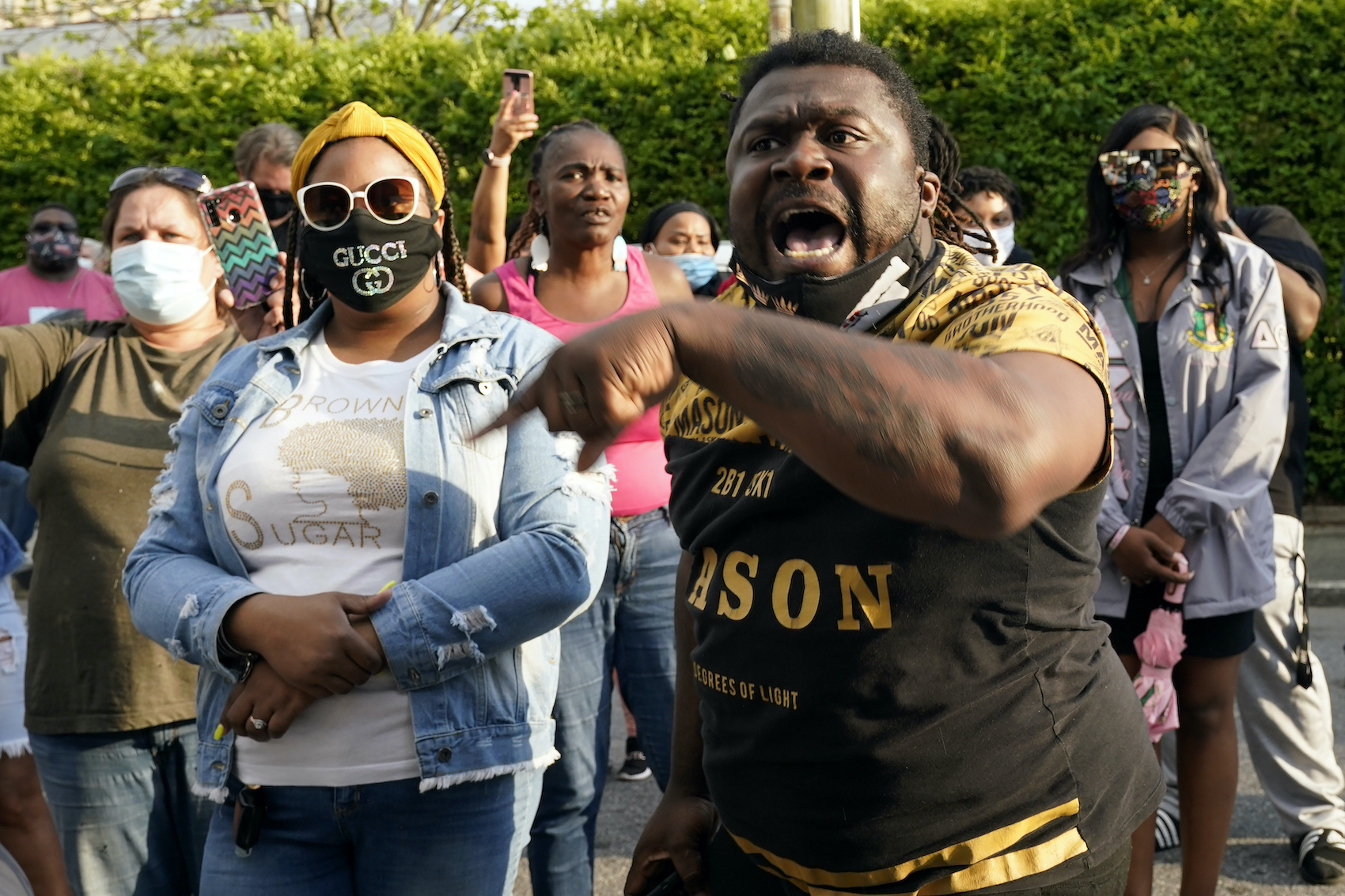 People gather outside the municipal building after at least one Pasquotank County Sheriff's deputy shot and killed a Black man while executing a search warrant
