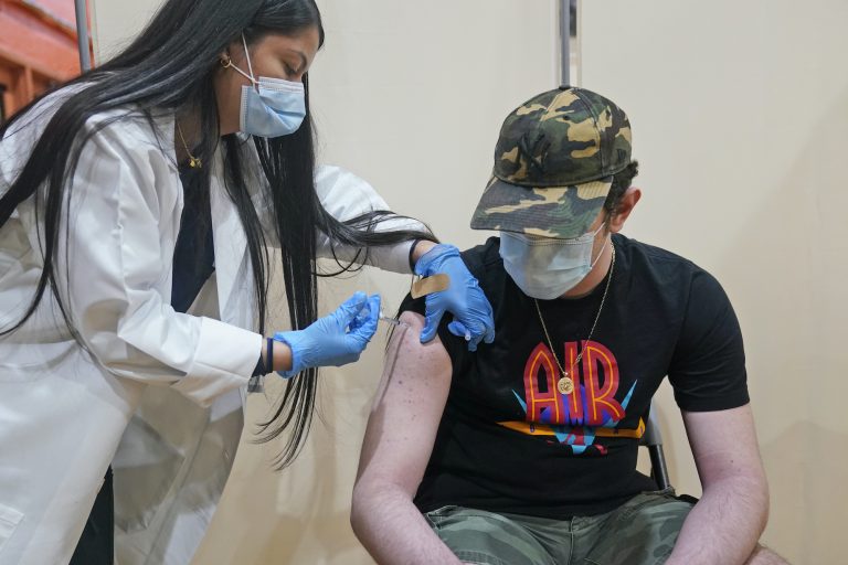 Alejandro Garcia, 16, receives his first dose of the Pfizer COVID-19 vaccine