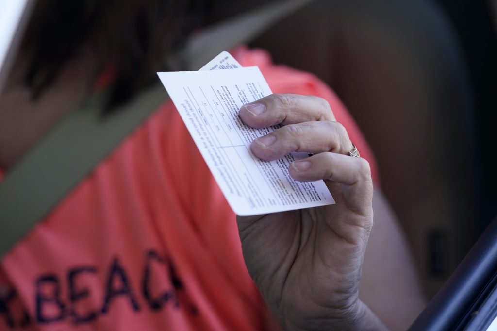 Virus Outbreak Louisiana Sandy Boeckl holds her inoculation card