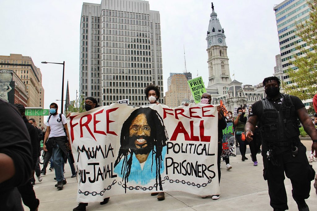 Protesters take to the streets to demand freedom for Mumia Abu Jamal. (Emma Lee/WHYY)