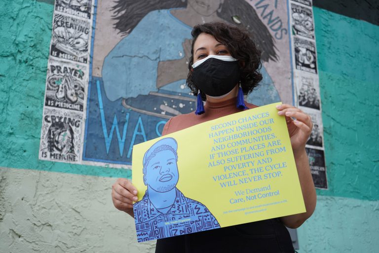 Artist Symone Salib helped create a poster campaign featuring portraits and quotes of previously incarcerated young people. (Kenny Cooper/WHYY)