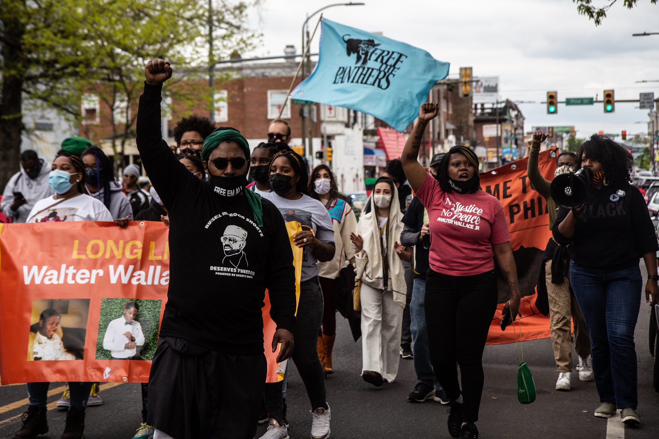 Protesters chanting for Black liberation and to free Mumia march down 52nd Street in West Philadelphia