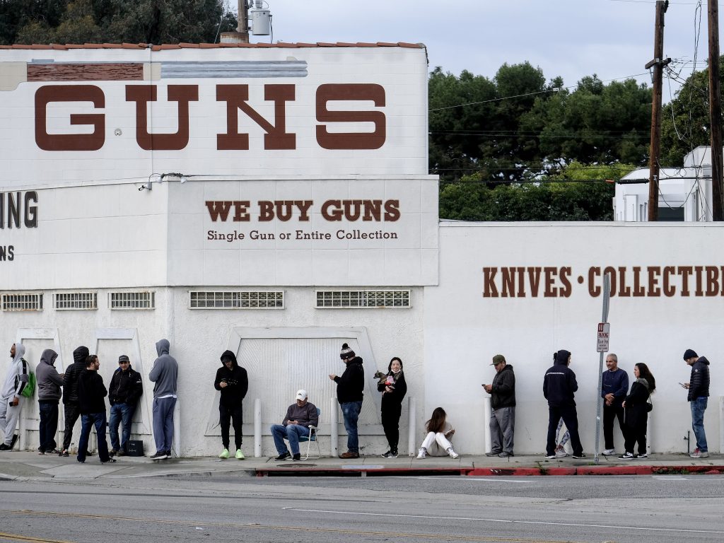 People wait in line to enter a gun store in Culver City, Calif., on March 15, 2020. People wait in line to enter a gun store in Culver City