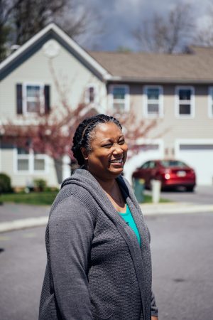 Marcia Pretlow stands on the sidewalk