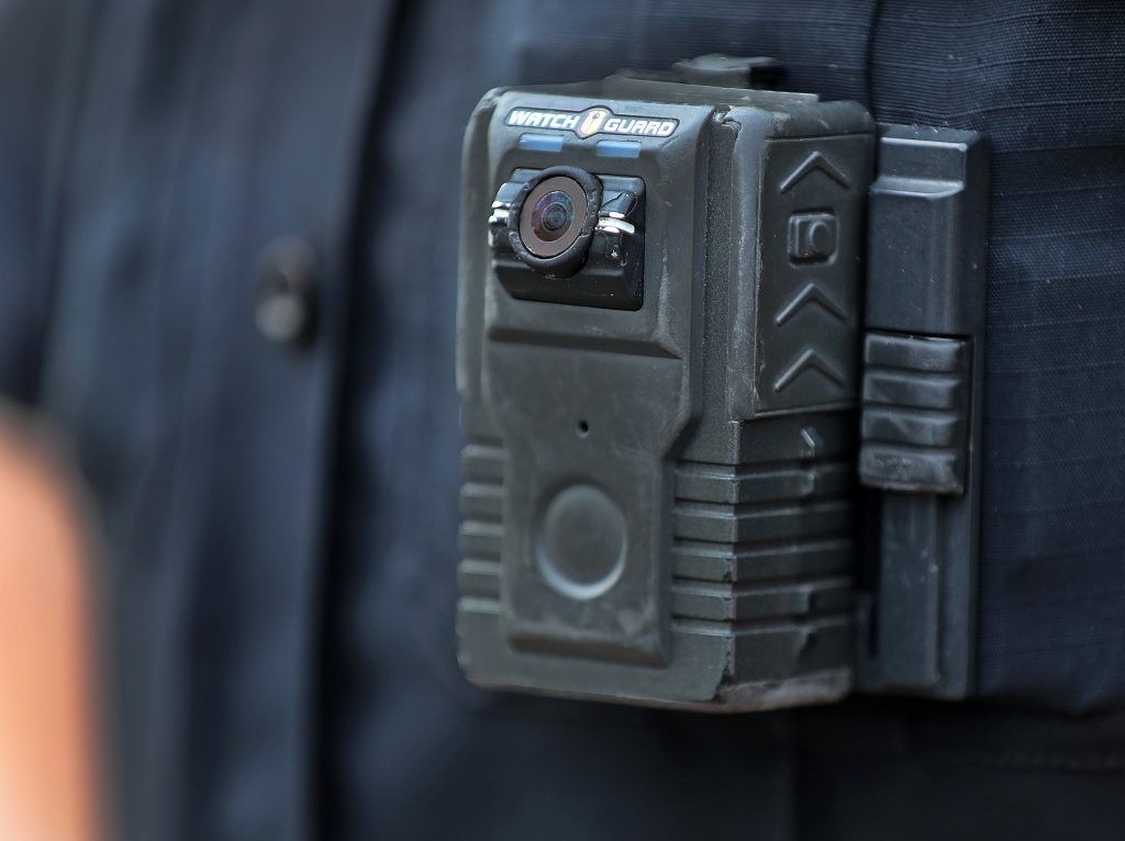 Police officer David Moore is pictured wearing a body camera in Ipswich, Mass., on Dec. 1, 2020. The city was among 25 statewide awarded grants to purchase body-worn cameras for videotaping interactions with the public. A new study says the benefits to society and police departments outweigh the costs of the cameras. Police officer David Moore is pictured wearing a body camera in Ipswich, Mass., on Dec. 1, 2020. The city was among 25 statewide awarded grants to purchase body-worn cameras for videotaping interactions with the public. A new study says the benefits to society and police departments outweigh the costs of the cameras. (Boston Globe/Boston Globe via Getty Images)