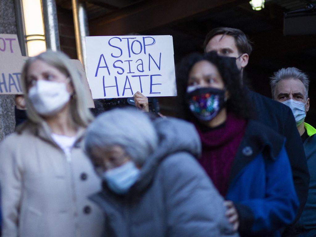 People attend an anti-violence press conference on Tuesday outside the building where a 65-year-old Asian woman was attacked in New York. People attend an anti-violence press conference on Tuesday outside the building where a 65-year-old Asian woman was attacked in New York.