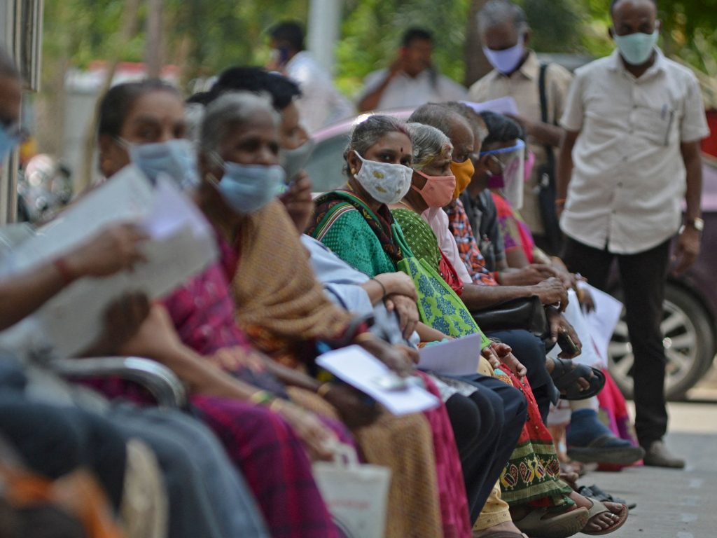 People wait for their turn to receive the COVID-19 vaccine at a government hospital in Chennai, India, on Friday. People wait for their turn to receive the COVID-19 vaccine