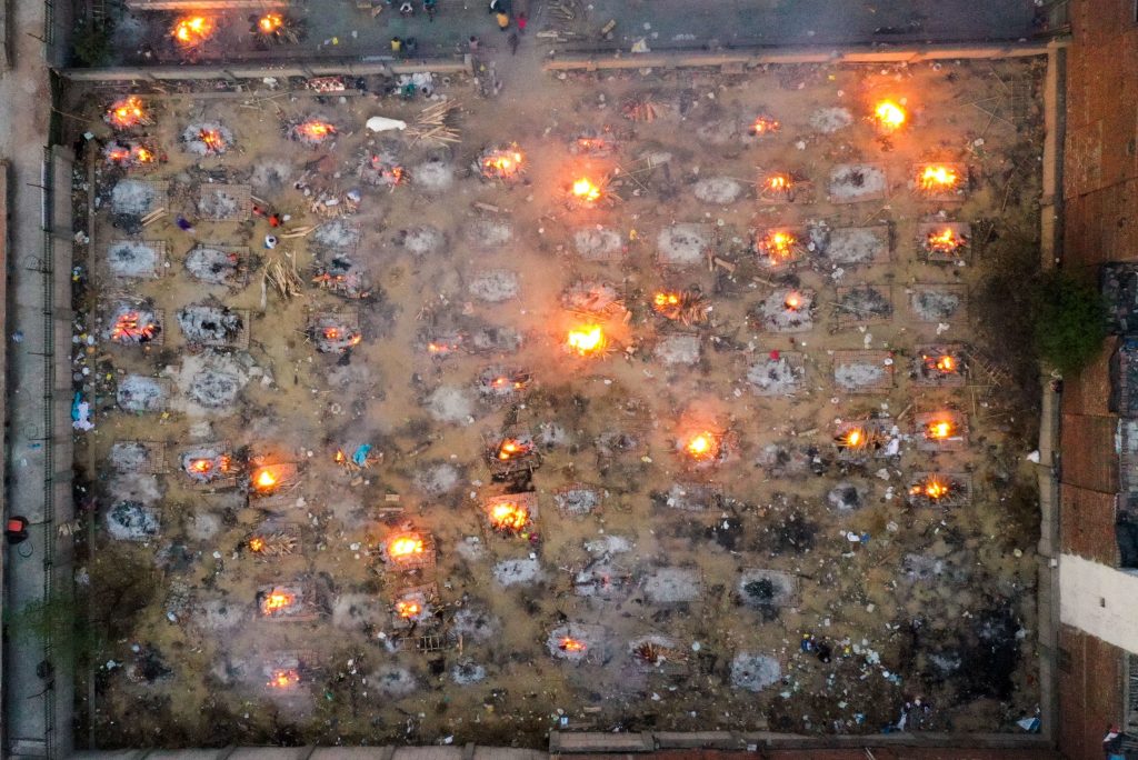 Victims of COVID-19 are cremated in funeral pyres this week in New Delhi. Scientists says the real death toll and number of infections are likely much higher than what the Indian government is reporting. Burning pyres of victims who lost their lives due to the coronavirus are seen at a cremation ground in New Delhi