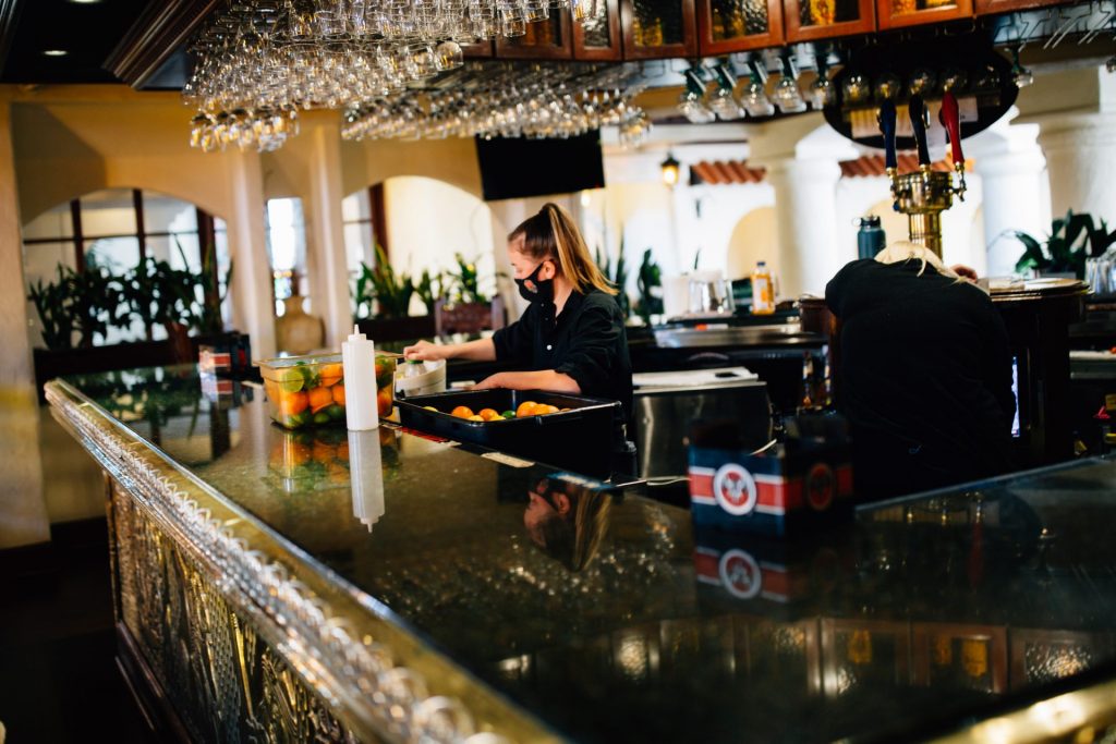 lancrestaurants-1-24-1920×1280 A bartender works while wearing a face mask
