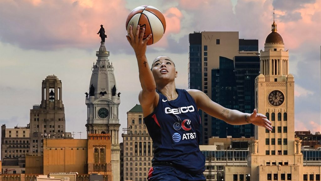 Mystics Cloud Basketball Natasha Cloud appears in the foreground with a basketball; the Philadelphia skyline appears in the background