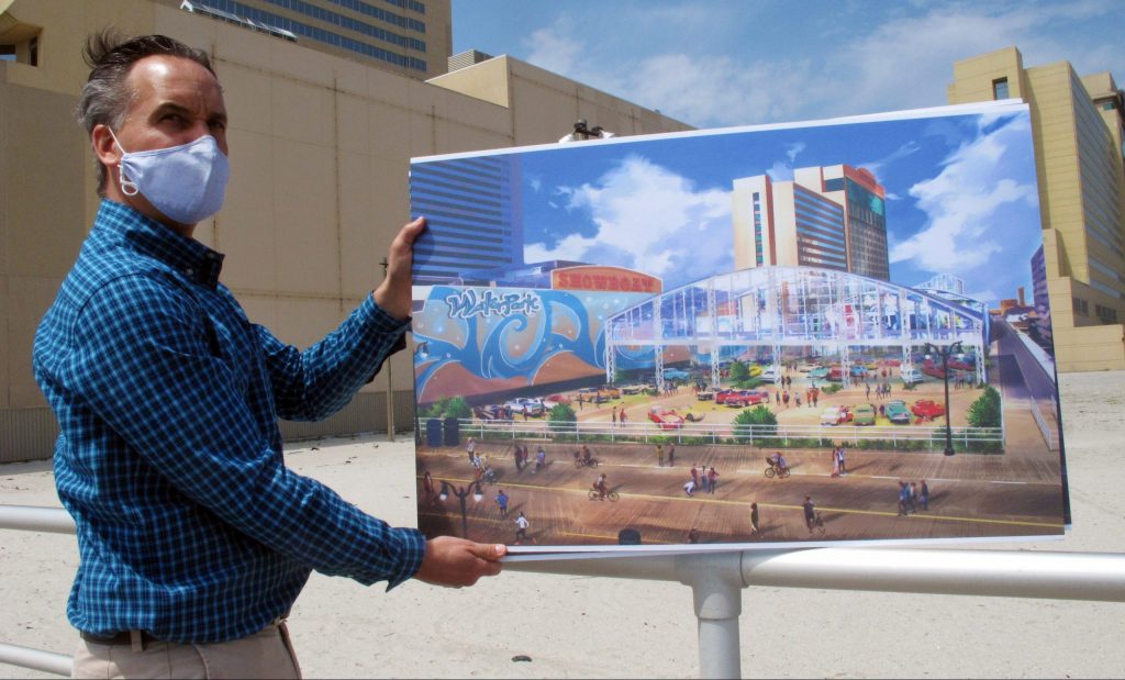showboat-atlantic-city-1-scaled-e1619170426419 Martin Sizmur, who is in charge of construction for Philadelphia developer Bart Blatstein, shows an illustration of an 8,000-seat domed concert hall to be built next to the Showboat casino, Wednesday, April 21, 2021, in Atlantic City, N.J.