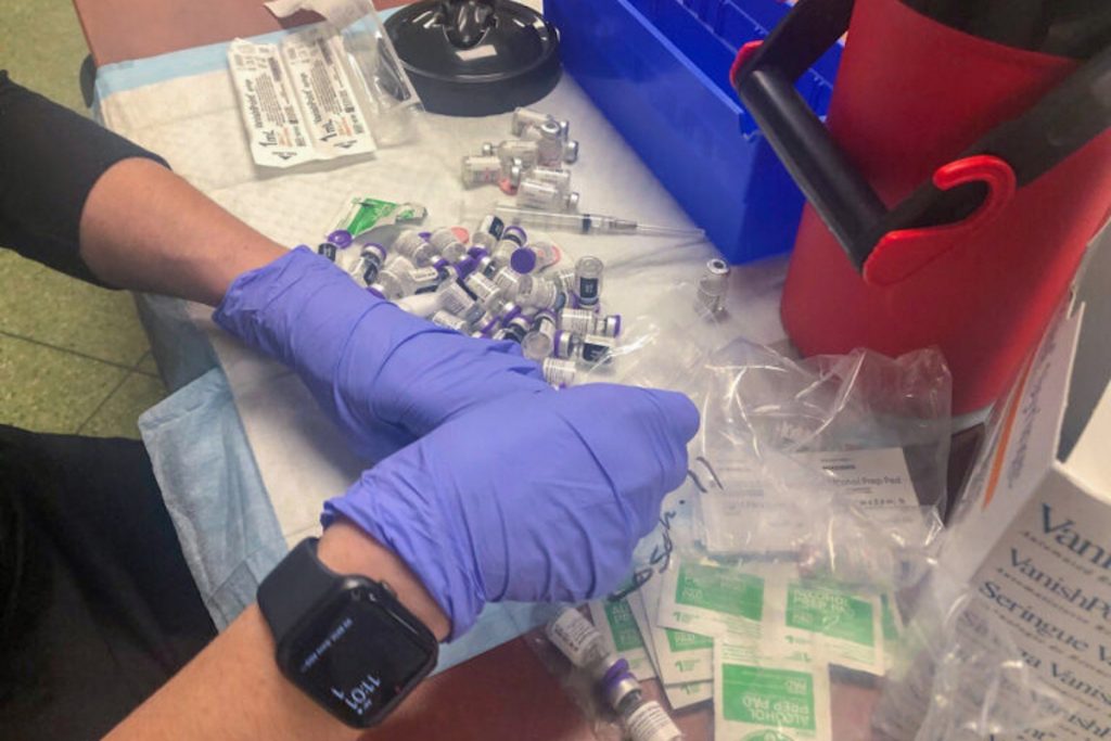 vaccines-1-768×576 A worker organizes vaccine doses during a recent event at Rose Hill Community Center near New Castle. (Cris Barrish/WHYY)