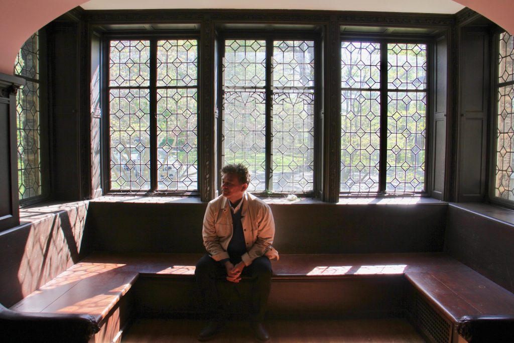 2021 04 26-e lee-william valerio-philadelphia chestnut hill st michael hall-woodmere seeks to buy 19th century mansion rose room William Valerio, director of the Woodmere Art Museum sits in the Rose Room at St. Michael Hall, envisioning the room as a performance venue. (Emma Lee/WHYY)