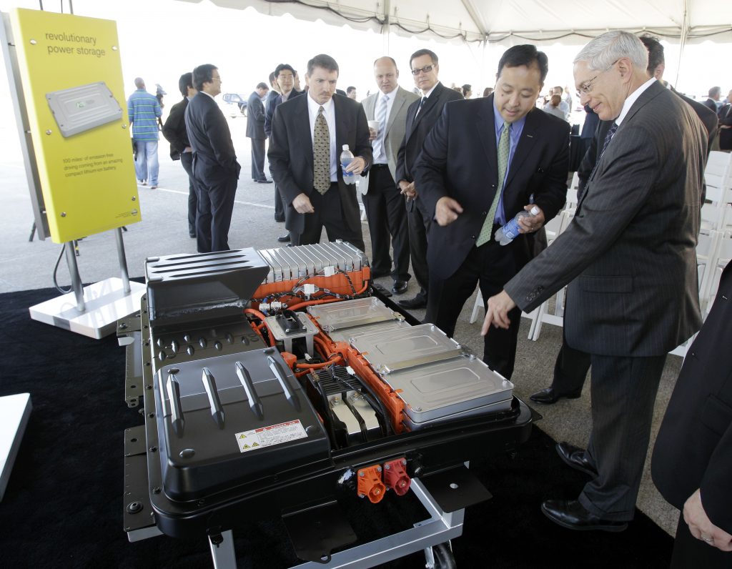 nissan leaf battery FILE- In this file photo made May 26, 2010, people look over the battery array of an all-electric Nissan Leaf in Smyrna, Tenn. Nissan North America, Inc. held its ground-breaking ceremony Wednesday for a lithium-ion battery plant as part of its plan to start building electric cars and eventually create up to 1,300 jobs in Tennessee. The auto industry calls it range anxiety: Drivers want electric cars but worry they won't have enough juice to make long trips. After all, what good is going green if you get stranded with a dead battery? It's a fear that automakers must overcome as they push to sell more battery-powered cars. So government and business are taking steps to reassure drivers by building up the nation's network of electric charging stations. (AP Photo/Mark Humphrey, File)