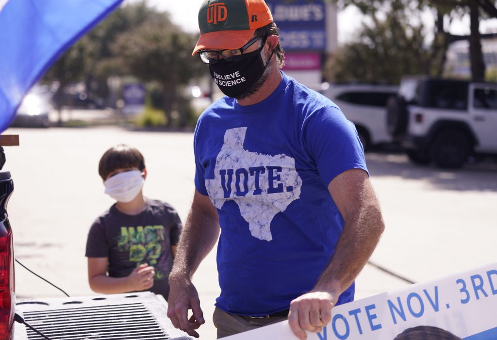 A supporter of Democratic presidential candidate former Vice President Joe Biden prepares for a Ridin' With Biden event Sunday, Oct. 11, 2020, in Plano, Texas. (AP Photo/LM Otero)