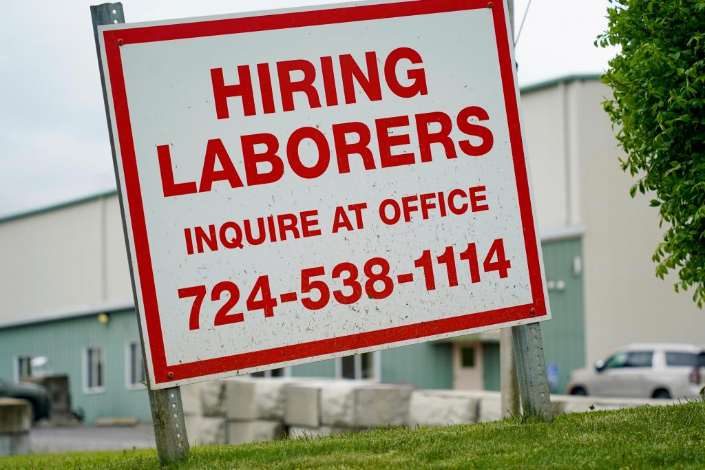 Unemployment Compensation Pennsylvania A sign seeking to hire laborers is posted outside a concrete products company in Evans City, Pa., Wednesday, May 5, 2021. A bill by Pennsylvania's Republican-controlled Legislature to reinstate work-search requirements for people claiming unemployment benefits cleared the House Labor and Industry Committee on a party-line vote Tuesday. Labor and Industry Committee Chairman Jim Cox, R-Berks, contends that employers are having trouble finding workers, and that they often blame the additional $300 per week in federal unemployment benefits during the pandemic and the lack of a work-search requirement. (AP Photo/Keith Srakocic)