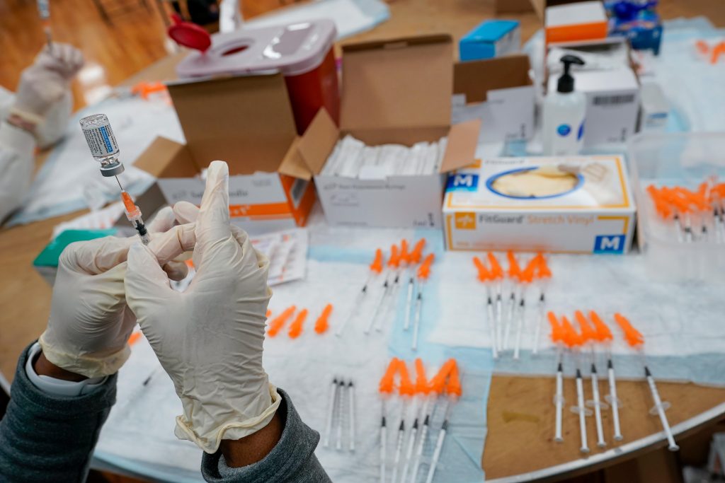 Virus Outbreak Vaccines A health worker fills up a syringe with the Johnson & Johnson vaccine