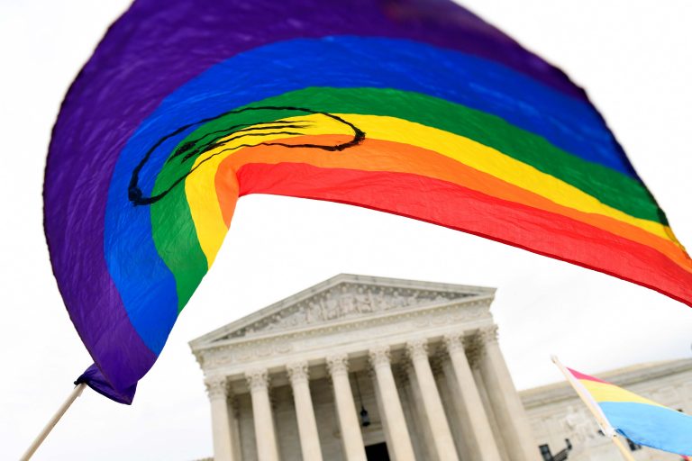 In this Oct. 8, 2019, file photo, protesters gather outside the Supreme Court in Washington. Legislation that would create new protections for LGBTQ Americans is stalling out in the U.S. Senate. Democrats were hopeful they could pass the Equality Act this year since they control Congress and the White House. (AP Photo/Susan Walsh)