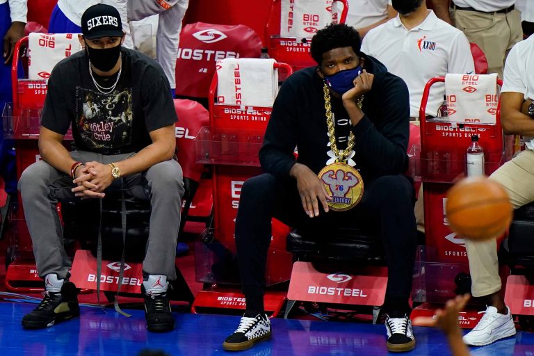 Philadelphia 76ers' Joel Embiid, right, and Ben Simmons watch from the bench during an NBA basketball game against the Orlando Magic, Sunday, May 16, 2021, in Philadelphia. (AP Photo/Matt Slocum)