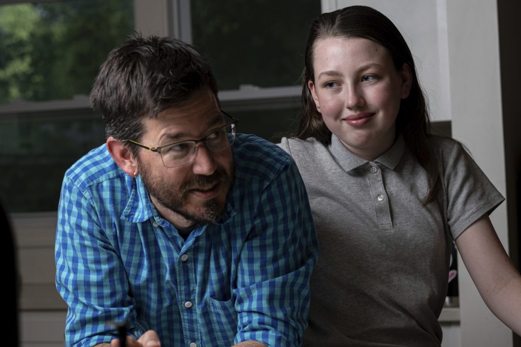 Virus Outbreak-Standardized Tests Jay Wamsted, left, and his daughter, Kira, are photographed on Thursday, May 20, 2021 in Smyrna, Ga. Wamsted, who is an 8th grade math teacher, allowed his daughter to skip testing this year. (AP Photo/Ben Gray)