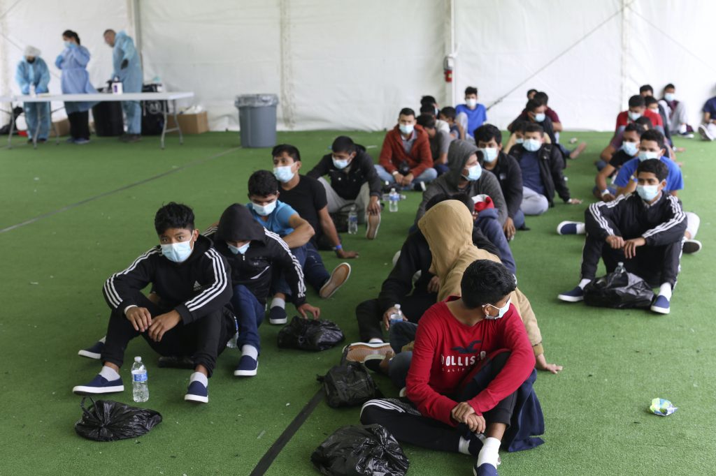 Young migrants wait to be tested for COVID-19 at the Donna Department of Homeland Security holding facility