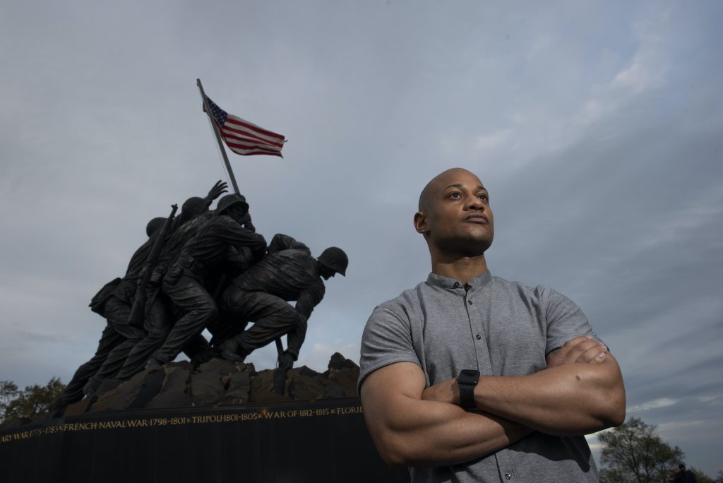 Racism In The Ranks Reserve Marine Maj. Tyrone Collier stands with his arms crossed in front of the U.S. Marine Corps War Memorial