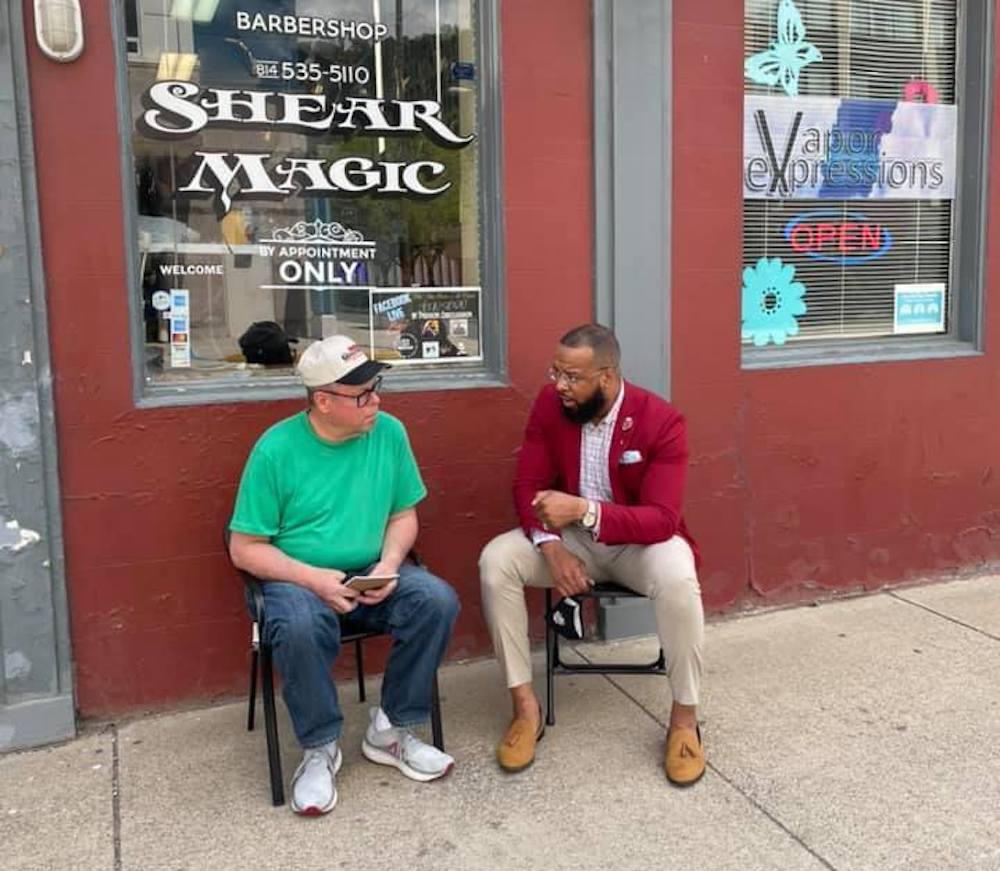 Brandon Flood speaking with a community member at a Barbershop in Johnstown PA Brandon Flood speaks with a community member outside a barbershop