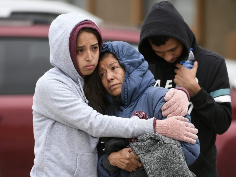 Family members hug each other on the street