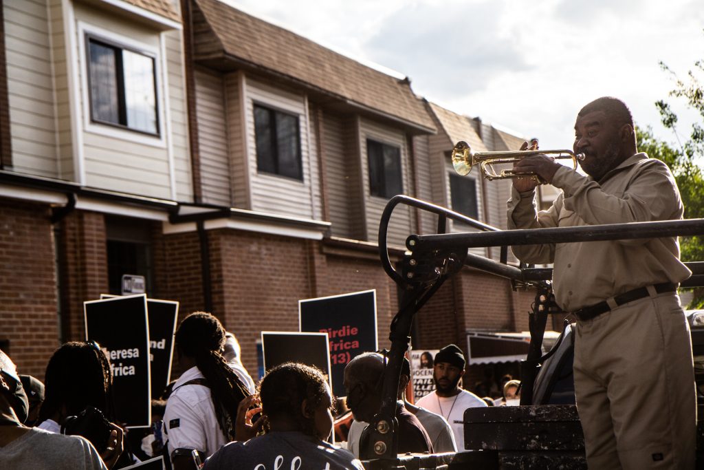 IMG_3470 Kenneth Taylor plays the trumpet during a rally to remember the victims of the MOVE bombing
