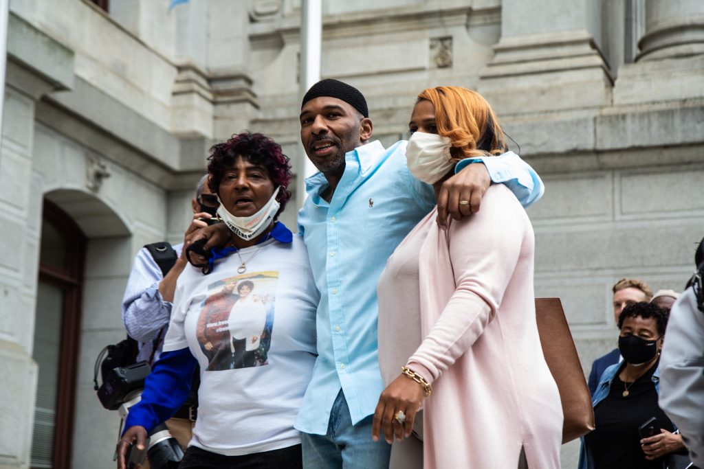 Eric Riddick (center), freed from prison after serving almost 30 years, with his mother Christine Riddick (left) and wife Dana Riddick (right) on May 28, 2021. (Kimberly Paynter/WHYY)