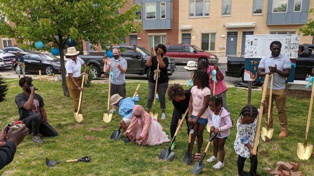 North Philly Peace Park volunteers and Sharswood community members break ground on the pavilion at a May 15 ceremony. (Courtesy of Kermit O)