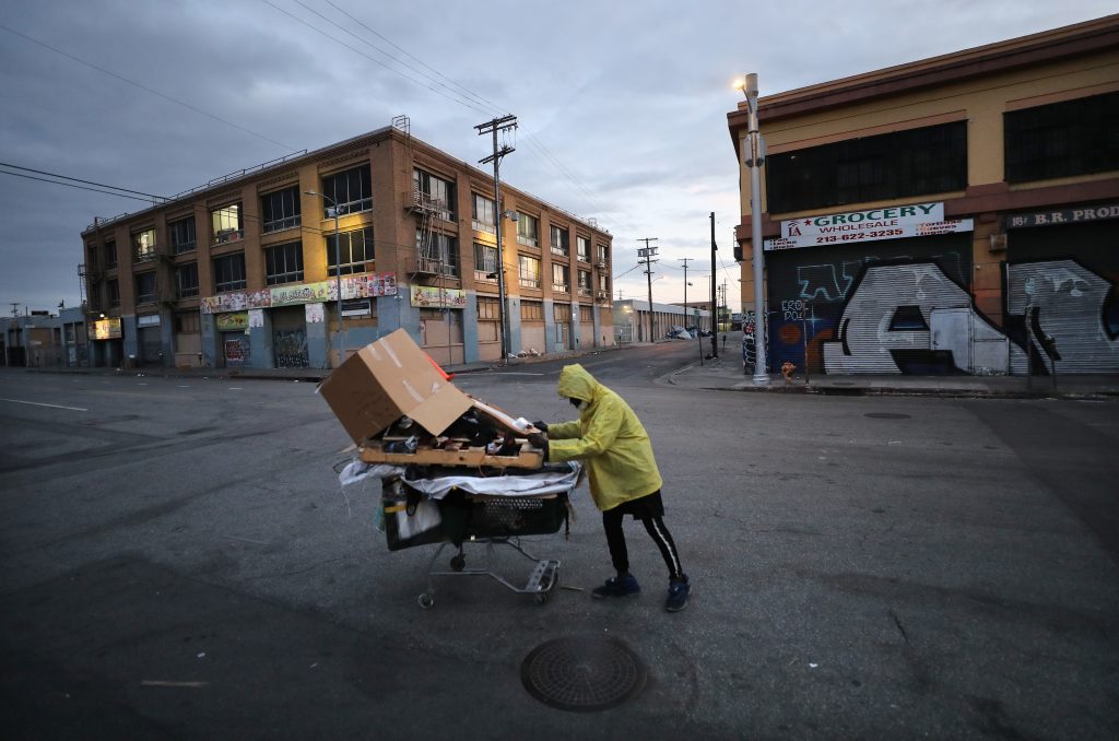 A homeless man pushes his belongings along a Los Angeles street. A homeless man pushes his belongings along a Los Angeles street. (Mario Tama/Getty Images)