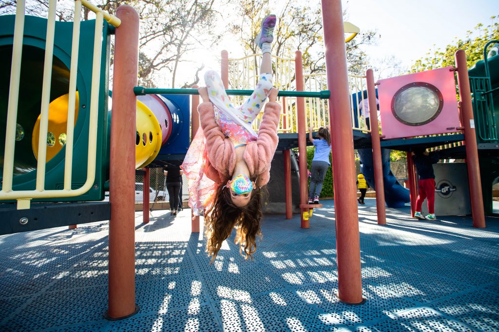 Robin Heilweil, 6, wears a mask while swinging around with her kindergarten class this month at Kenter Canyon School in Los Angeles. Robin Heilweil, 6, wears a mask while swinging around with her kindergarten class this month at Kenter Canyon School in Los Angeles. (Sarah Reingewirtz/Los Angeles Daily News/Southern California News Group via Getty Images)