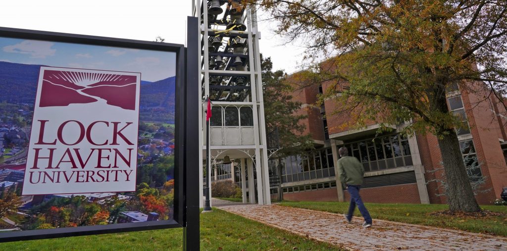 lock-haven-1-scaled-e1616144627743 A student walks on the Lock Haven University campus in Lock Haven, Pa, Saturday, Oct. 31, 2020. (Gene J. Puskar/AP Photo)